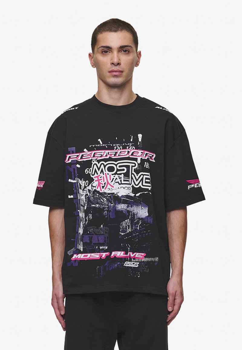 Black oversized t-shirt with graphic prints in purple and pink text. Features short sleeves and a crew neck, made of cotton fabric.