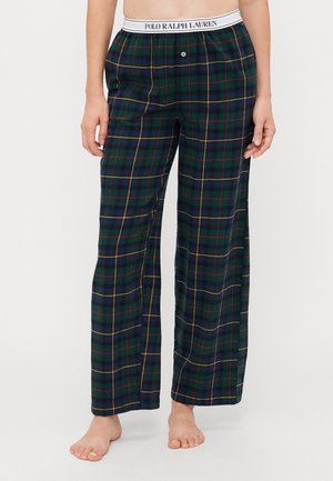 Žalios ir mėlynos plaid naktinės kelnės su geltonais akcentais. Yra balta elastinga juosmens juosta su logotipu ir vienu mygtuko užsegimu.
