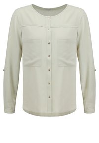 Blouse beige clair à manches longues avec boutons, encolure ronde et deux poches poitrine, avec pattes boutonnées sur les manches pour ajustement roulé.