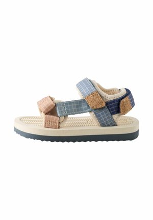 Child’s open-toe sandal with beige sole and multicolored blue and pink adjustable fabric straps with cork details.