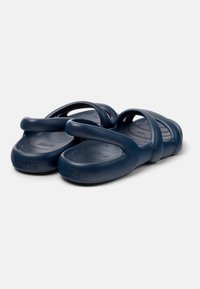 Navy blue rubber sandals with multiple straps and textured footbed. Lightweight design with engraved brand logo on the sole.
