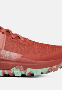 Scarpe da trail running in corallo e menta, con una tomaia testurizzata in mesh e accenti in gomma, e una suola robusta per la trazione.