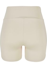 Crème gekleurde shorts met een hoge tailleband, gemaakt van gladde stof. Heeft een aansluitend ontwerp zonder zichtbare naden of zakken.