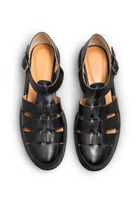 Black leather sandals with a woven design, open toe, and adjustable ankle strap. Smooth texture and a tan insole.