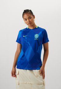 Blue football jersey with geometric patterns and a gradient design. Features a round neckline with neon green accents and Brazil emblem.