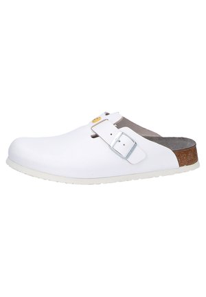 White clogs with a smooth finish, adjustable strap, and contrasting brown cork footbed. Lightweight outsole for comfort and durability.