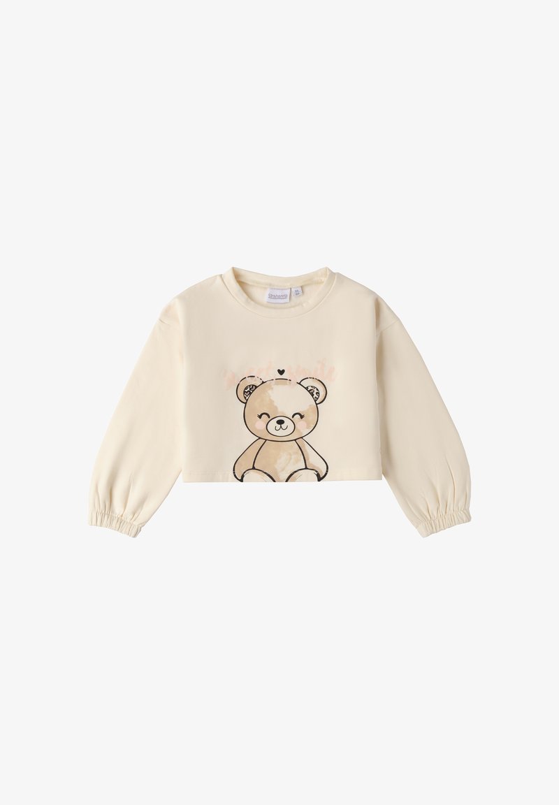 Sudadera corta color crema con mangas largas y abullonadas. Presenta una impresión de un oso con un corazón encima y una textura de tela suave y lisa.