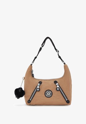Light brown Kipling handbag with black adjustable strap, diagonal front zippers, round logo patch, and a black furry keychain accessory.