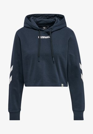 Marineblauwe cropped hoodie van zachte, gestructureerde stof. Voorzien van een capuchon, trekkoorden en contrasterende witte chevrons op de mouwen. Hummel-logo gedrukt op de voorkant.
