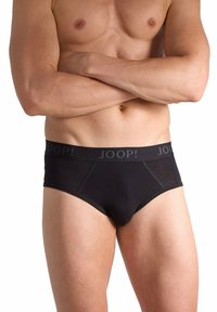 Bóxers negros confeccionados en tela suave con una cintura gris que muestra la marca "JOOP!". Decorados con detalles de costura para un diseño ajustado.