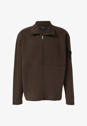 Bruine pullover top van zachte stof, met een halve ritssluiting bij de kraag, lange mouwen en een patch op de linkerarm. Eenvoudig ontwerp.