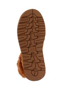 Semelle extérieure en caoutchouc brun avec une texture et un motif de grip présentant des formes en zigzag et angulaires, conçue pour l’adhérence et la durabilité.
