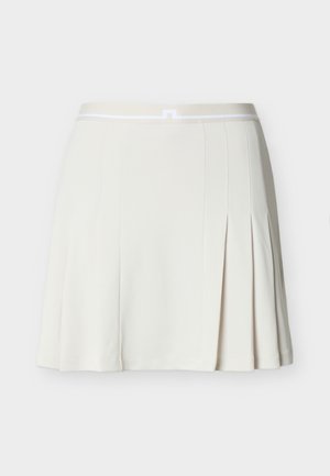 Valge volditud seelik, millel on elastne vöökoht, peene horisontaalse triibuga ja väike keskel asuv luku detail.