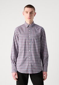 Camicia a righe con maniche lunghe, caratterizzata da un motivo rosso, blu e bianco, realizzata in cotone, con una piccola tasca e colletto.