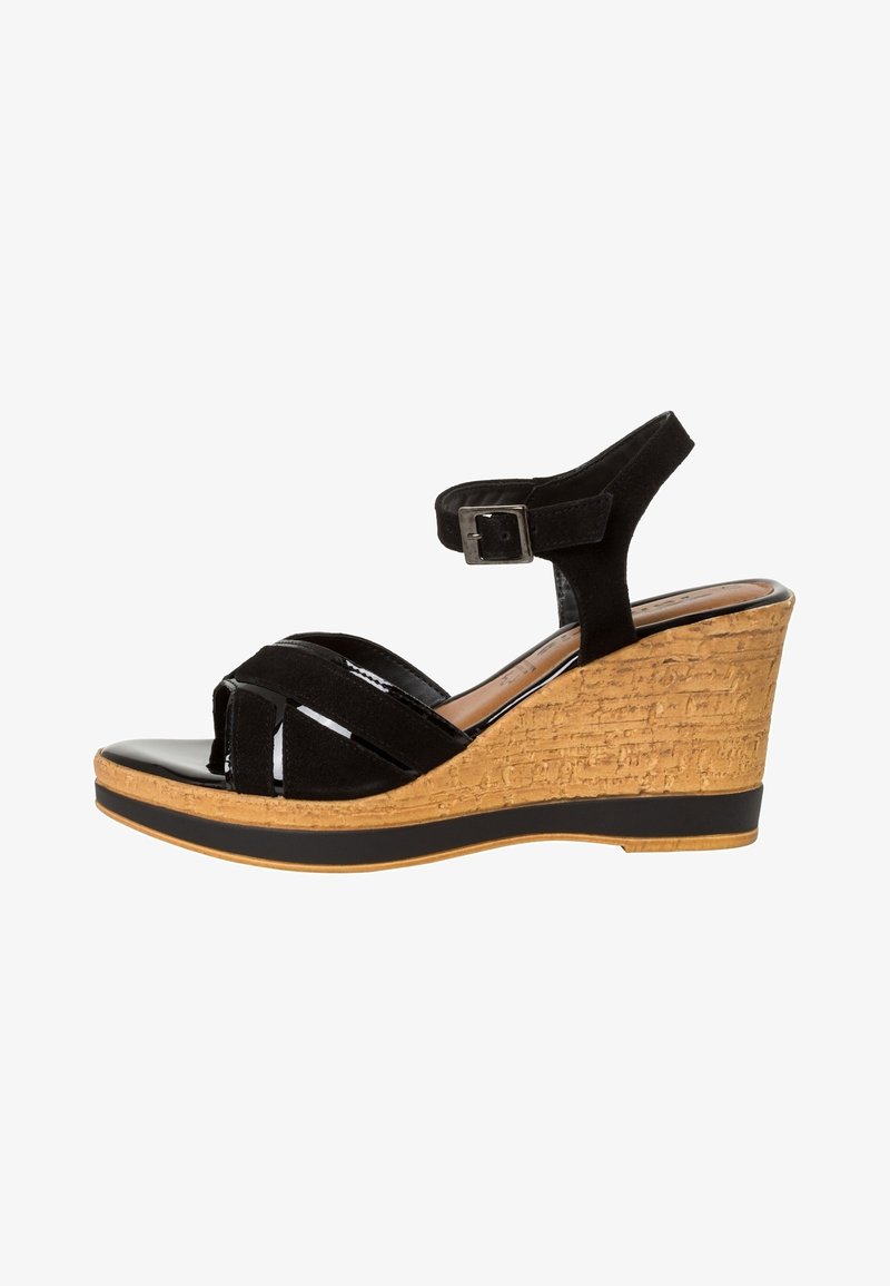 Black wedge sandals with a textured cork heel, open toe, and ankle strap. The upper features a combination of matte suede and shiny accents.