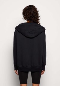 Black hooded sweatshirt with a relaxed fit, kangaroo pocket, ribbed cuffs, and hem; soft cotton blend fabric, smooth texture.