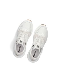 White sneakers featuring mesh and suede materials, rounded shape, contrasting gray accents, and prominent black branding on the tongue.