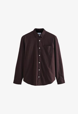 Rjava srajca z dolgimi rokavi in gumbi, ki ima klasičen ovratnik, en sam žep na prsih in bele gomme na teksturirani tkanini.