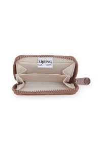 Kipling wallet in light brown with a zip closure. Interior features compartments and a fabric lining. Tag visible with brand name.