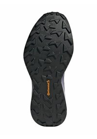 Suola in gomma nera con un motivo di battistrada robusto e forme variabili. Include un logo "Continental" di colore arancione ben visibile.