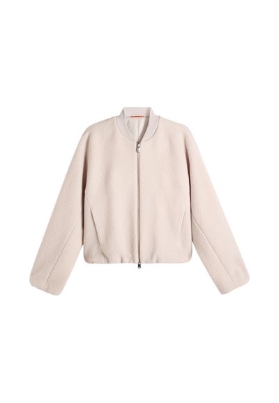Light beige fleece jacket with long sleeves and a front zipper, featuring a ribbed collar and a simple, clean design.