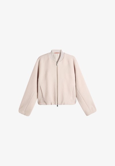 Light beige fleece jacket with long sleeves and a front zipper, featuring a ribbed collar and a simple, clean design.