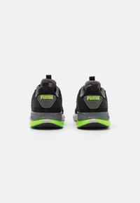 Black athletic shoes with gray accents, mesh upper, and lime green heel detail. Features a padded collar and pull tab for easy wear.