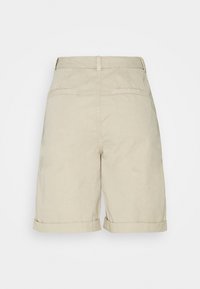 Pantaloni corti in lino beige con design a risvolto, caratterizzati da una superficie liscia e due tasche posteriori, mostrati dalla vista posteriore.