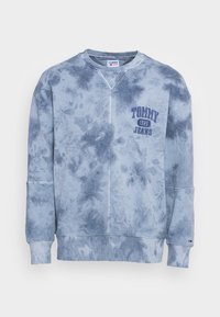 Felpa azzurra tie-dye con polsini e orlo a coste, con la scritta "Tommy Jeans 1985" ricamata sul petto in lettere blu scuro.