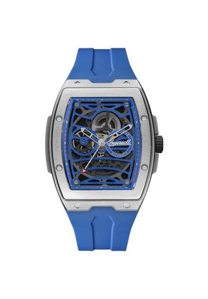 Montre automatique avec boîtier en acier inoxydable, cadran squeletté bleu et bracelet en silicone bleu assorti. Présente des accents rouges et un mouvement complexe.