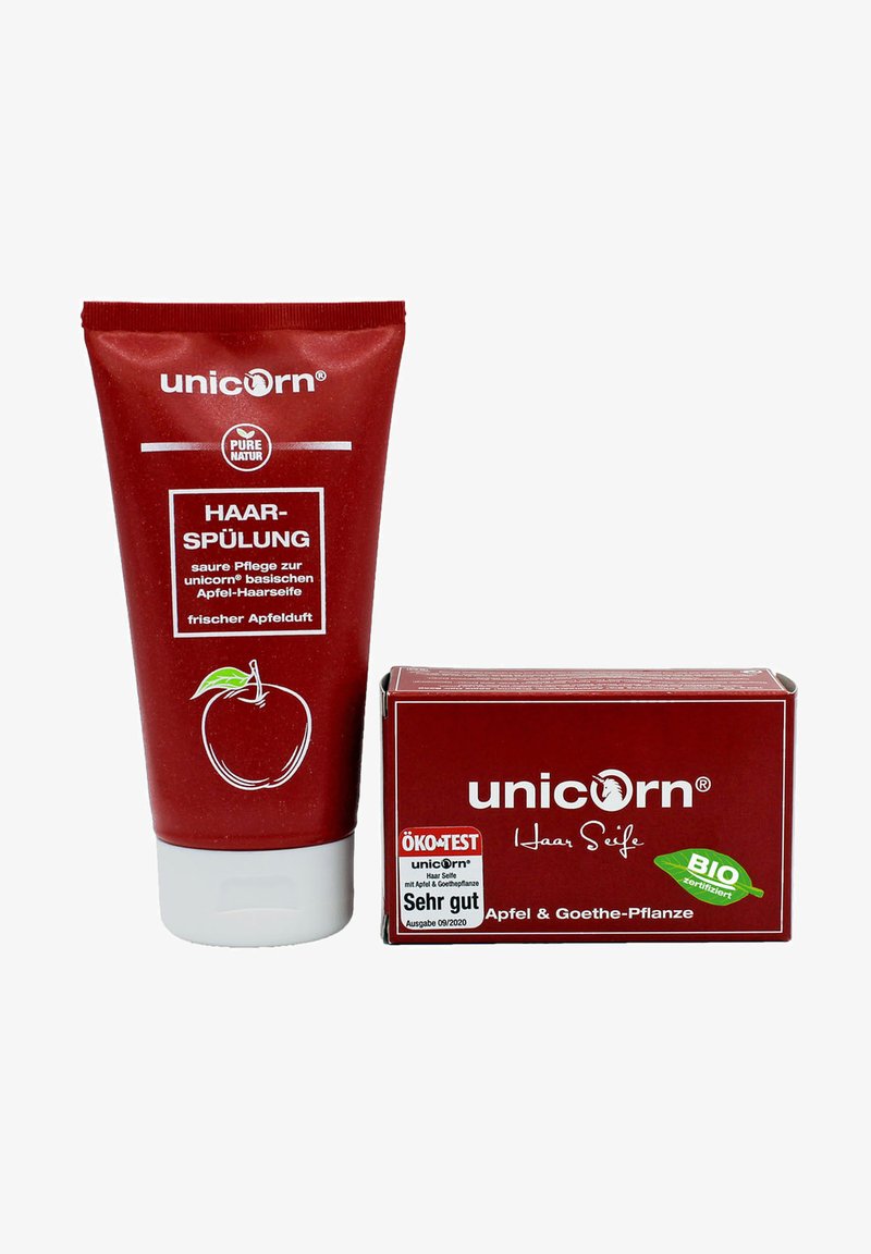 Red tube of hair conditioner with apple graphic, labeled "Haar-Spülung." Next to it, a red box of hair soap, labeled "Haar Seife" and marked "ÖKO-TEST."