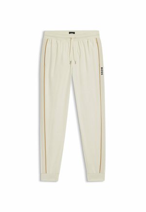 Cream-colored sweatpants featuring a drawstring waist, tapered legs, contrast gold side stripes, and a black logo on the left leg.