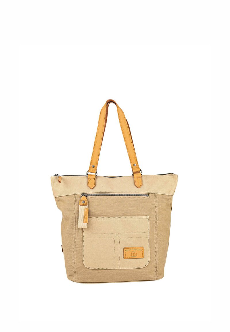 Bolsa de lona en beige con asas de cuero amarillo. Cuenta con un bolsillo frontal, cierre con cremallera y un detalle de etiqueta de cuero.