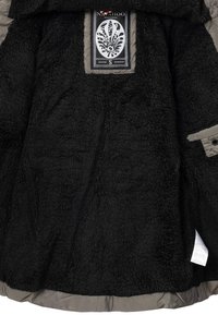Black fleece jacket featuring a soft, textured interior with a beige lining, complete with a brand label in the center.