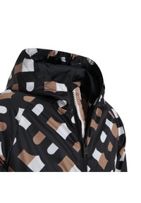 Water-resistant black jacket with a hood, featuring a geometric pattern in white and brown. Zippered front with black trim.