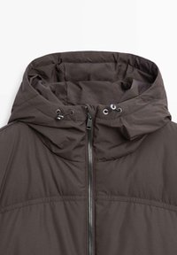 Dark gray jacket with padded hood, front zipper, and adjustable drawstrings on the hood.