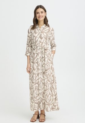 Maxi-jurk in beige met witte botanische print, knoopsluiting aan de voorkant, kraag en taille met strik. Zachte stof, lange mouwen, zijzakken en enkel lengte.