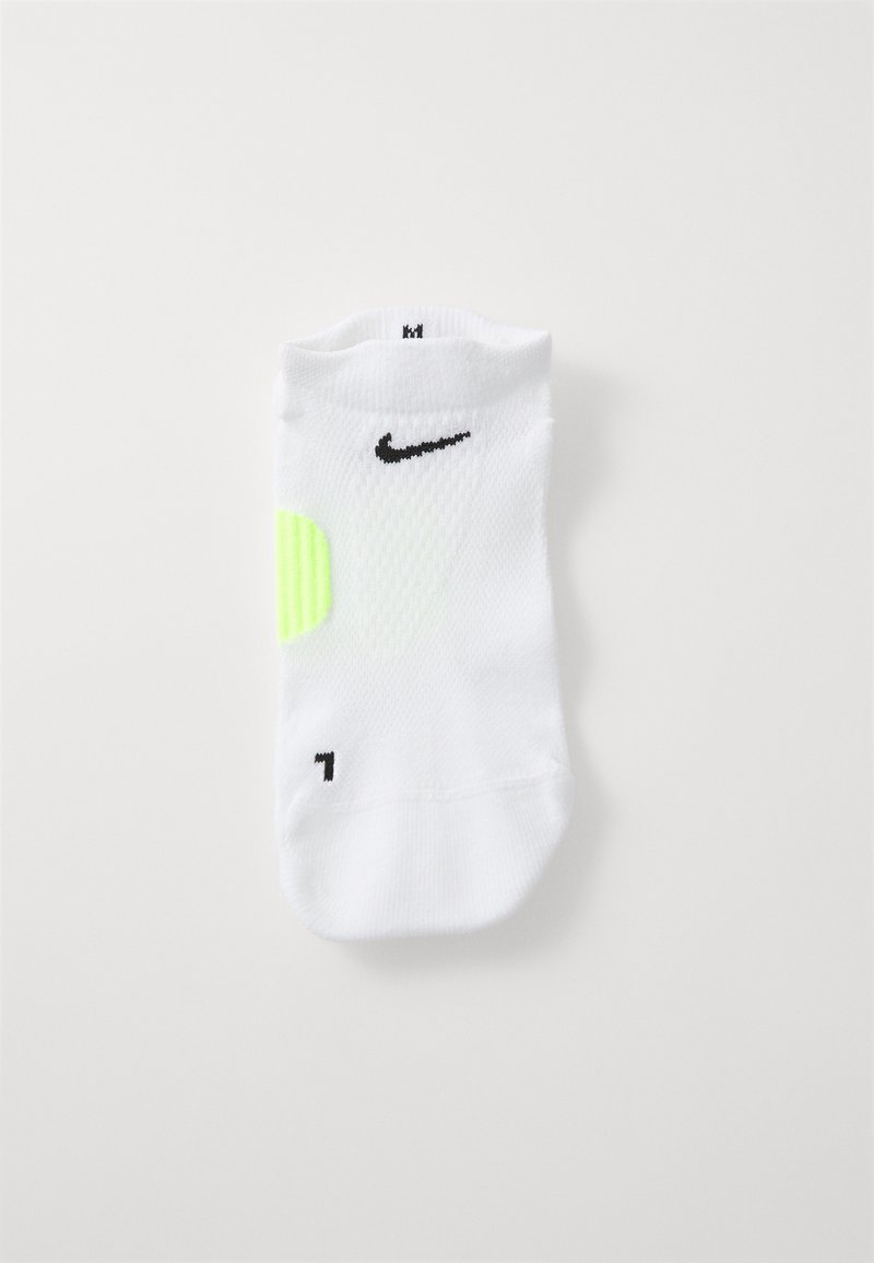White athletic sock with black Nike logo, bright neon yellow accent, ribbed texture on the body, and a black number "7" at the foot.