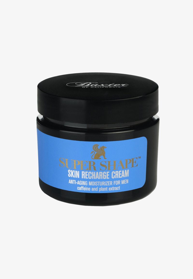 Barattolo cilindrico nero con un'etichetta blu caratterizzata da testo dorato. L'etichetta riporta "Crema Ricarica Pelli Super Shape", che indica proprietà anti-invecchiamento.