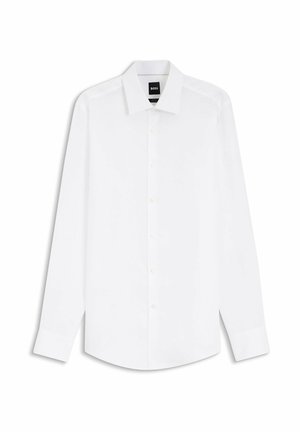 Chemise habillée blanche pour homme à manches longues, avec fermeture boutonnée sur le devant et col pointu, présentée à plat sur un fond blanc.