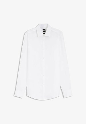 Camicia da uomo bianca a maniche lunghe con chiusura frontale a bottoni e colletto appuntito, mostrata distesa su uno sfondo bianco.