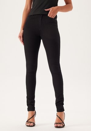 Zwarte skinny jeans gemaakt van elastische denim, met een medium hogere taille, subtiele stiksels en een klassiek vijf-pocket ontwerp.