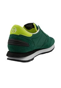 Baskets vertes et noires avec une tige en suede et nylon. Comprend un col de cheville rembourré et une semelle matelassée ; inclut un détail de logo sur le talon.