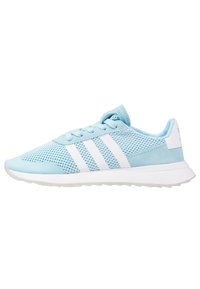 Light blue athletic shoe made of mesh and suede, featuring three white stripes, a rounded toe, and a textured rubber sole.
