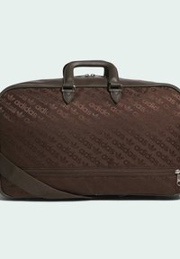 Brown Adidas bag with a textured pattern featuring repeated logos. It has a sturdy handle, adjustable shoulder strap, and zip closure.