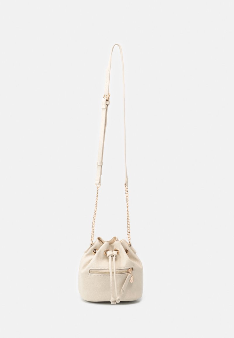 Small beige bucket bag with drawstring closure, front zip pocket, gold chain sides, and adjustable shoulder strap.