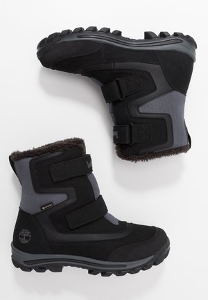 Bottes d'hiver isolées noires et grises avec des sangles Velcro, des semelles robustes et une doublure en fourrure, conçues pour le froid et une utilisation extérieure.