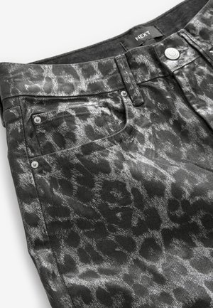 Mustad denim teksad, millel on läikiv leopardimuster, viie tasku kujundus ja hõbedased metallosad. Brändi silt on nähtav vöökoha juures.