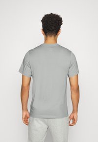 Gray short-sleeve t-shirt with a crew neckline, made of soft fabric, featuring a simple design and a relaxed fit. No visible graphics.
