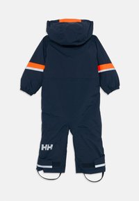 Tamnoma modra otroška snovna obleka z kapuco, oranžnimi in odsevnimi črtami na rokavih ter nastavljivimi trakovi na hlačnicah.
